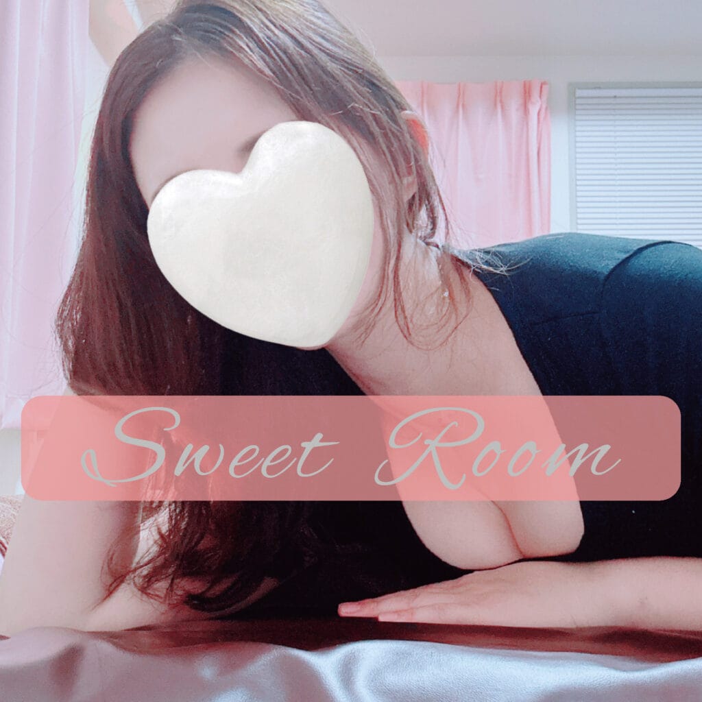 a woman lying on a bed with a heart shaped object over her face